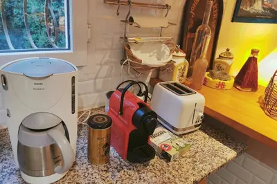 a kitchen counter with a coffee maker and a toaster at Villa 140 m2 avec piscine, parc privatif 5000m2 à Bonifacio-Porto Vecchio in Bonifacio