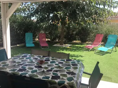 a table and four chairs in a yard at Villa A Nuciola - Prunete in Cervione