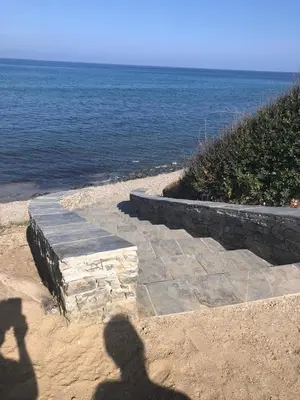 a shadow of a person taking a picture of the ocean at Villa A Nuciola - Prunete in Cervione