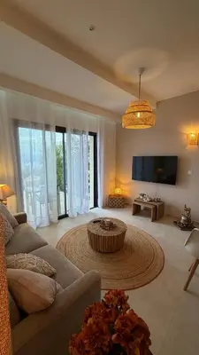 a large living room with a couch and a tv at Baia Serena in Ajaccio
