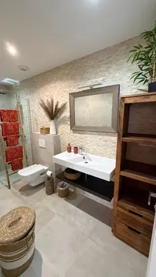 a bathroom with a sink and a toilet and a mirror at Baia Serena in Ajaccio