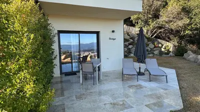 a patio with a table and chairs and a view at Baia Serena in Ajaccio