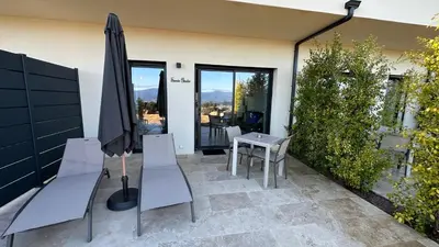 a patio with an umbrella and a table and chairs at Baia Serena in Ajaccio