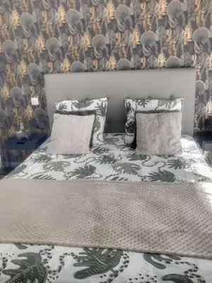 a bedroom with a bed with two pillows at L'Immortelle in Zonza