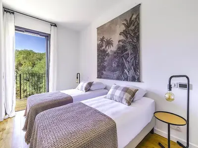 two beds in a white room with a window at Villa Paolina in Olmeto