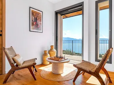 a living room with two chairs and a chess board at Villa Paolina in Olmeto