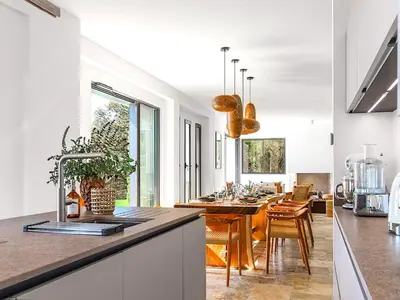 a kitchen and dining room with a dining table at Villa Paolina in Olmeto