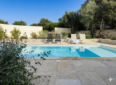 a swimming pool with two lawn chairs next to it at Casa Caseddu, Heated pool, 4 people, Bonifacio in Bonifacio