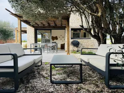 a group of couches and tables in a yard at Casa Caseddu, Heated pool, 4 people, Bonifacio in Bonifacio