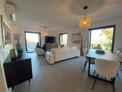 a living room with a couch and a mirror at Bergerie avec piscine à Sotta vue maquis in Sotta