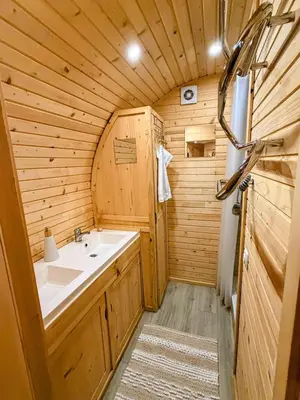 a bathroom with a sink in a wooden cabin at Roulotte Atypique - Vue Mer - Écrin de Nature in Cauro