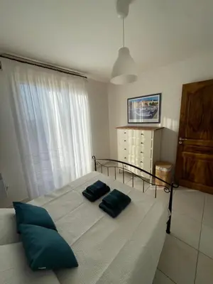 a bedroom with a bed with two pillows on it at Casa di Piero e Anna in Porto-Vecchio