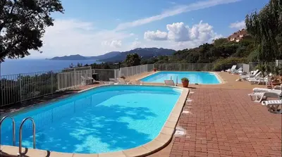 a swimming pool with a view of the ocean at Casa di Piero e Anna in Porto-Vecchio