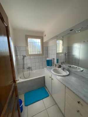 a bathroom with two sinks and a large mirror at Casa di Piero e Anna in Porto-Vecchio