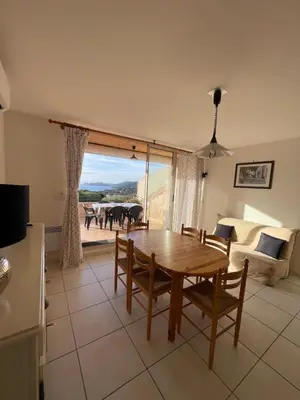 a living room with a table and chairs and a couch at Casa di Piero e Anna in Porto-Vecchio