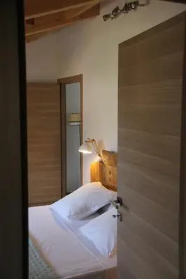 an open door to a bedroom with a bed at Casa di a Volpe in Corte