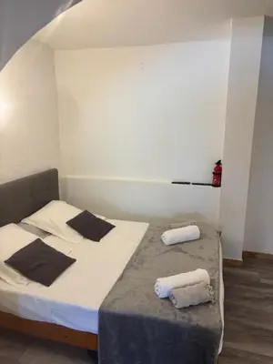 a bedroom with a bed with two towels on it at Casa di a Volpe in Corte