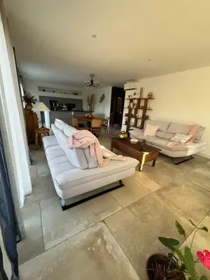 a living room with two white couches and a table at Maison de charme entre mer et nature 4pers in Cervione
