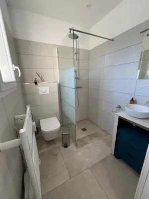 a bathroom with a shower and a toilet and a sink at Maison de charme entre mer et nature 4pers in Cervione