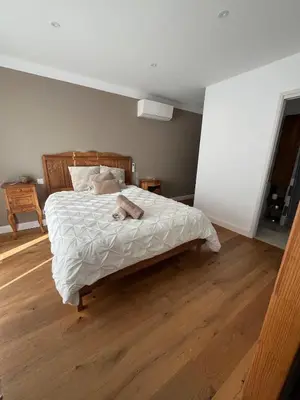 a bedroom with a bed with a dog laying on it at Maison de charme entre mer et nature 4pers in Cervione