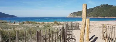a wooden fence on a beach near the ocean at U ghjosu rossu, Maison indépendante, bien située in Appietto