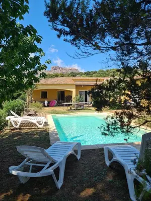 a pool with two lounge chairs and a house at U ghjosu rossu, Maison indépendante, bien située in Appietto