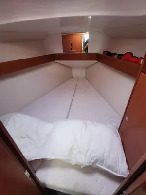 a large white bed in a small room at Voilier in Propriano