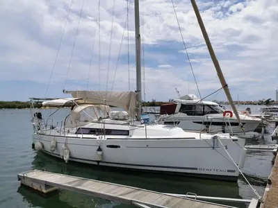 a white sailboat is docked at a dock at Voilier in Propriano