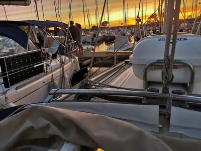 a group of boats docked in a harbor at sunset at Voilier in Propriano
