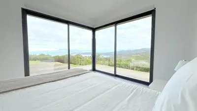 a bedroom with a bed and a large window at Panoramic Sea View - Heated Pool - Comfort in Coti-Chiavari