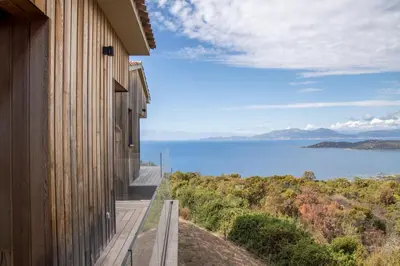 an open kitchen and dining room with a table and chairs at Panoramic Sea View - Heated Pool - Comfort in Coti-Chiavari