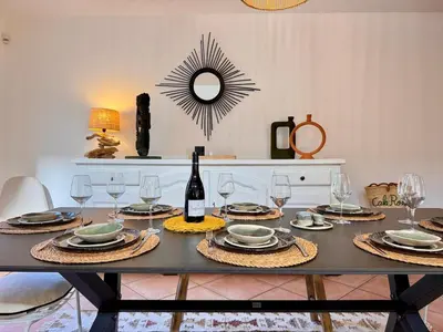 a dining table with glasses and a bottle of wine at Villa avec piscine - Cala Rossa - Accès plage in Lecci
