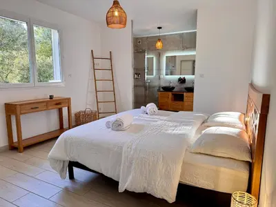 a bedroom with a large bed with towels on it at Villa avec piscine - Cala Rossa - Accès plage in Lecci