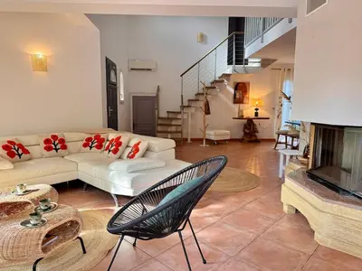 a living room with a couch and a fireplace at Villa avec piscine - Cala Rossa - Accès plage in Lecci