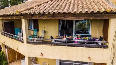 a balcony of a house with a table of food on it at A nostra casetta corsa, Carina, en bord de mer in Ghisonaccia