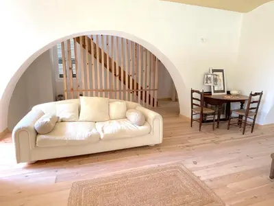 a living room with a white couch and a table at L'appartement Vinosa in Aléria