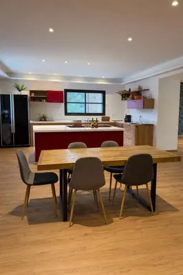 a kitchen with a large wooden table and chairs at Maison de campagne in Sartène
