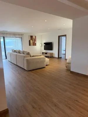 a living room with a couch and a flat screen tv at Maison de campagne in Sartène