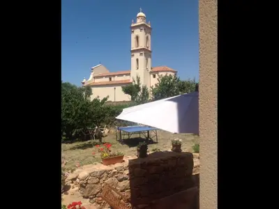 a large building with a clock tower in front of it at A Stalla in Piana