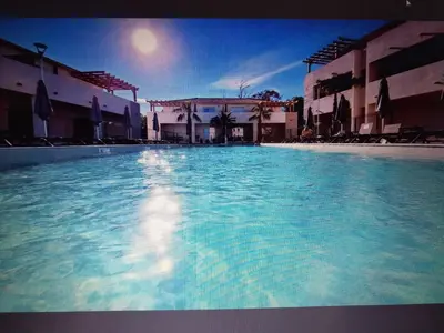 a large pool of blue water in a building at T3 bord de mer corse N 138 in Linguizzetta
