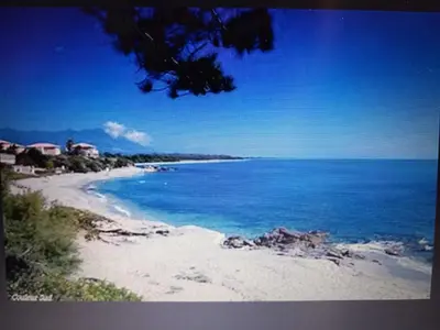 a view of a beach with the blue water at T3 bord de mer corse N 138 in Linguizzetta