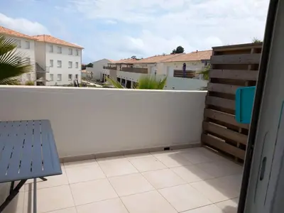 a balcony with a bench and a white fence at T3 bord de mer corse N 138 in Linguizzetta