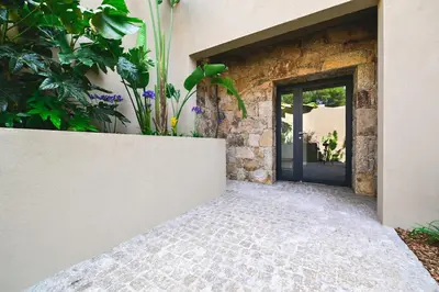 a front door of a house with a stone wall at Villa A Pinnata in Albitreccia