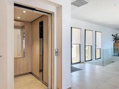 a hallway with a wooden door and a row of windows at Villa A Pinnata in Albitreccia