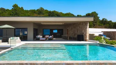 a swimming pool in front of a house at Villa A Pinnata in Albitreccia
