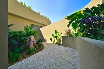 a walkway in front of a house with flowers and plants at Villa A Pinnata in Albitreccia