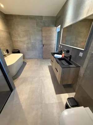 a bathroom with a tub and a sink and a toilet at New apartment, 3 bedrooms, sea view in Porto-Vecchio