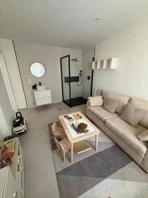 a living room with a couch and a table at New apartment, 3 bedrooms, sea view in Porto-Vecchio