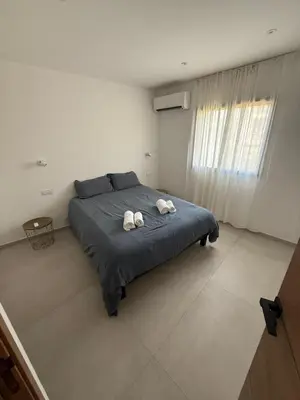 a bedroom with a bed with two towels on it at New apartment, 3 bedrooms, sea view in Porto-Vecchio