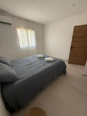 a bedroom with a bed with two towels on it at New apartment, 3 bedrooms, sea view in Porto-Vecchio